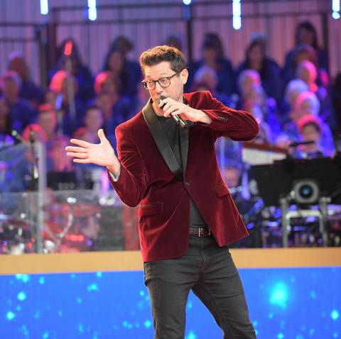 Rob Mills on stage at Carols by Candlelight
