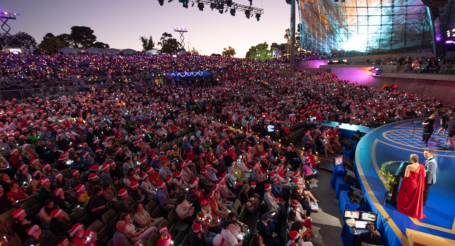 Side of stage looking up at the Carols crowd, and see some performers on stage