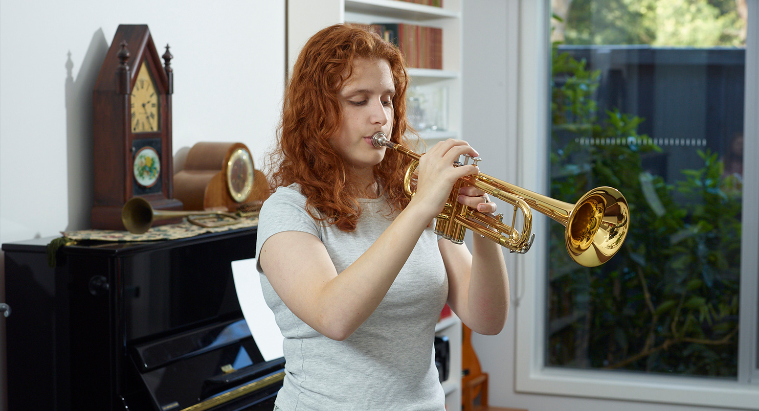 Lilly plays the trumpet