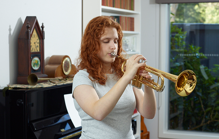 Lilly plays the trumpet